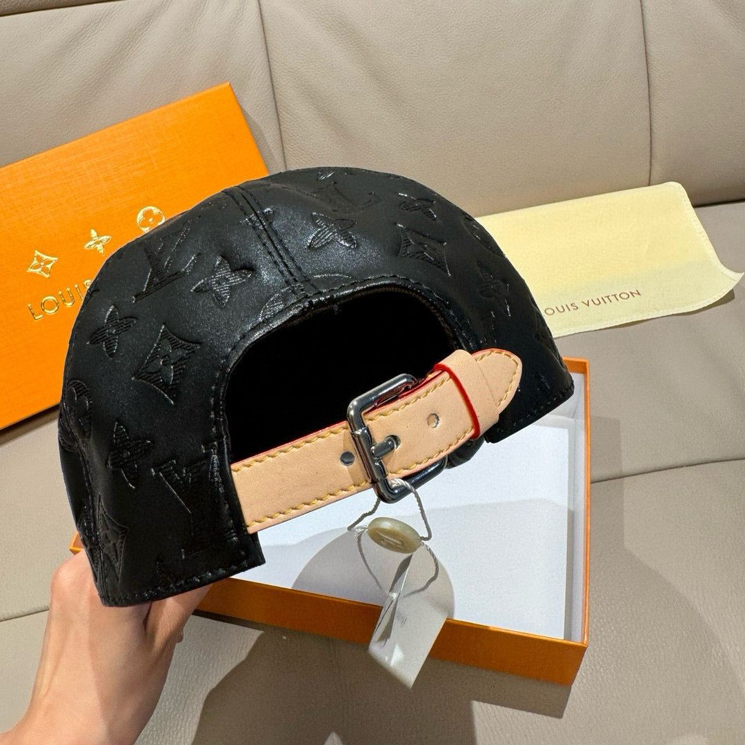 Louis Vuitton monogram cap, black embossed leather with tan adjustable buckle strap