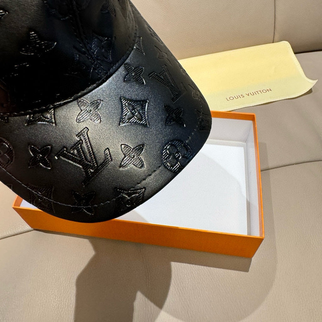 Louis Vuitton monogram cap detail, black embossed leather with repeating icons