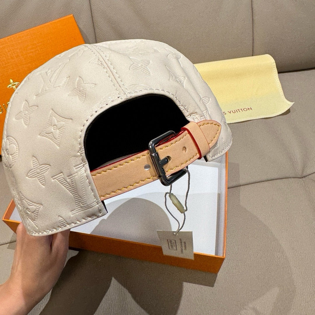 Louis Vuitton white monogram cap with adjustable tan strap and buckle