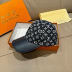 Louis Vuitton baseball cap on display, black monogram print with navy brim.