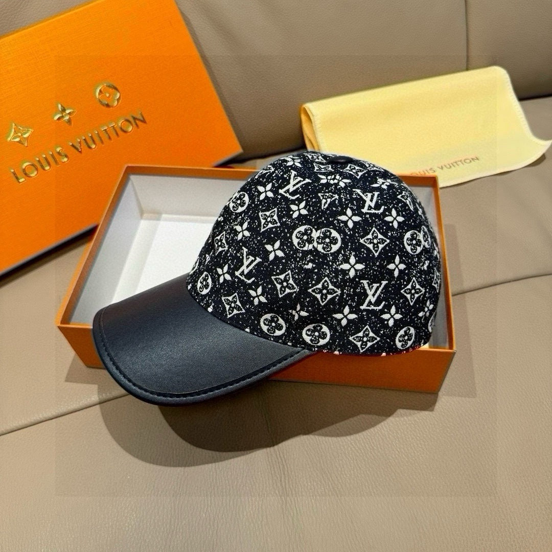Louis Vuitton baseball cap on display, black monogram print with navy brim.
