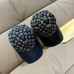 Louis Vuitton baseball cap pair, black monogram tops with navy brims side by side.