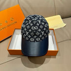 Louis Vuitton baseball cap with black monogram-style pattern and navy curved brim.