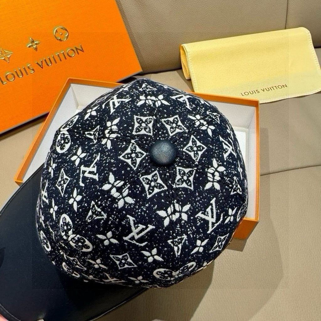 Louis Vuitton baseball cap top view with black monogram print and round dark button.