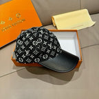 Black cap with white monogram-style print and black brim with contrast stitching