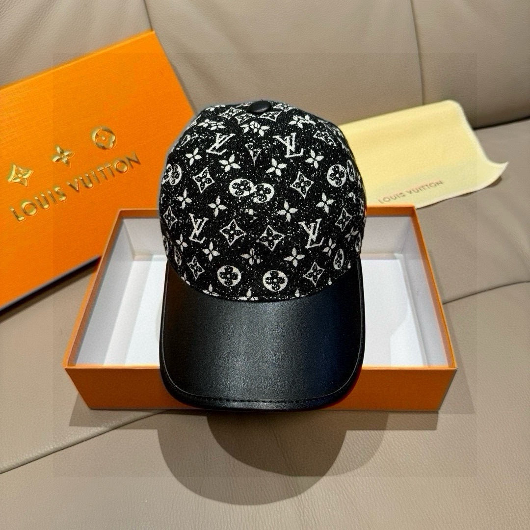 Black baseball cap with white monogram-style pattern and black curved brim