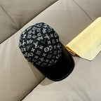 Black monogram-pattern cap with rounded crown and black curved brim
