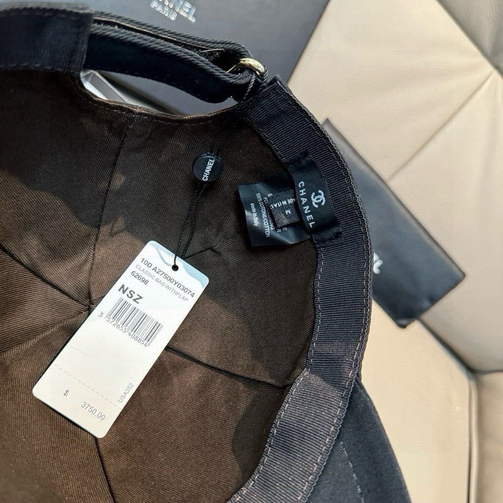 Black fabric cap interior with adjustable strap and Chanel woven label