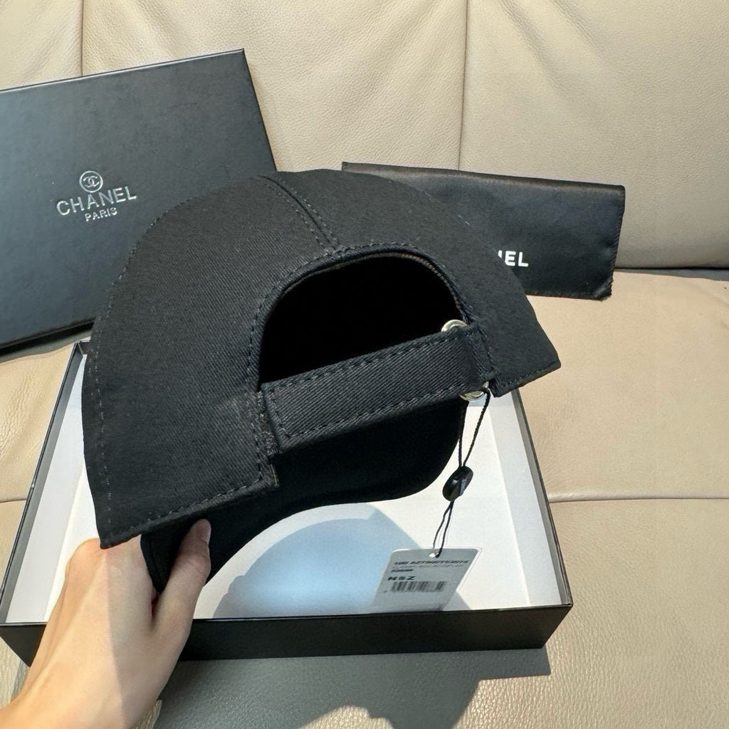 Black baseball cap with adjustable strap and open interior panel