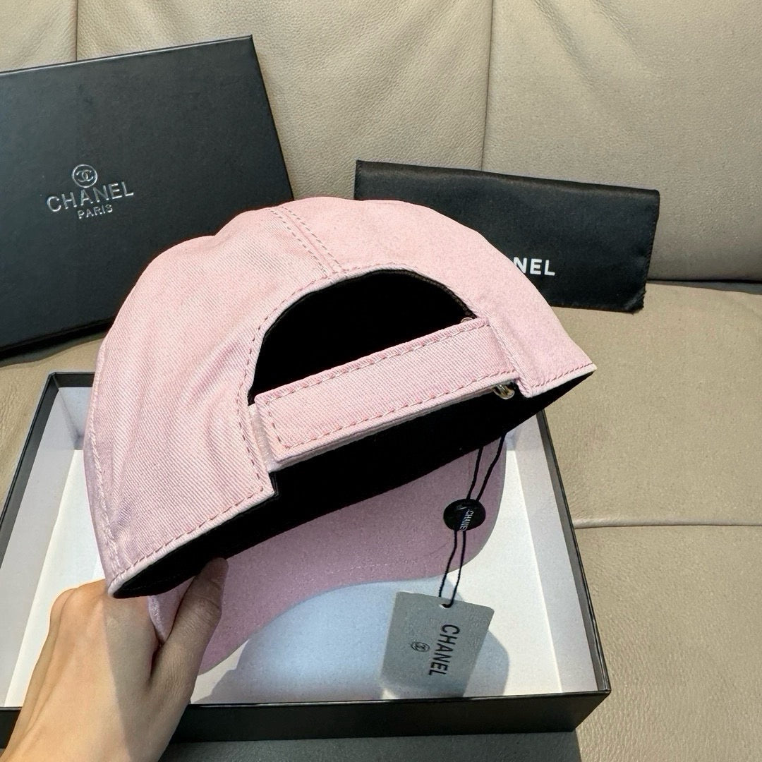 Pink baseball cap with black interior lining and adjustable strap.