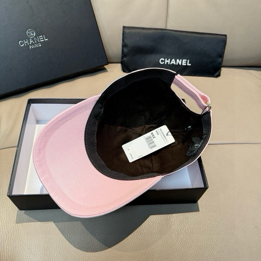 Pink baseball cap with black interior lining and visible inner tag.