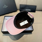 Pink baseball cap with black interior lining and visible inner tag.