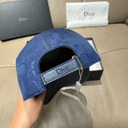 Blue Dior cap with black adjustable band and open interior brim.