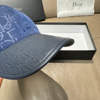 Blue Dior cap brim detail with repeating monogram texture.