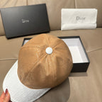 Dior cap with tan monogram crown, white brim, round top button detail.