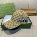 Gucci baseball cap in brown GG canvas with logo patch across the front strap.