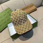 Gucci baseball cap with brown GG monogram pattern, curved brim, and front logo stripe.