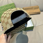 Gucci baseball cap showing adjustable strap with black leather patch and GG monogram body.