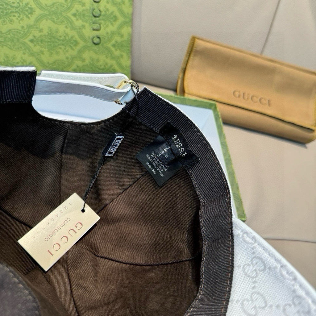 Gucci cap interior with brown lining and hangtag, visible seam and adjustable strap.