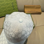 Gucci baseball cap top view in white GG monogram fabric with round button detail.