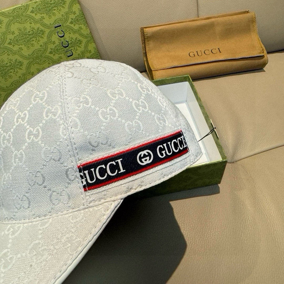 Gucci baseball cap close-up: white GG monogram crown with logo trim band at brim.