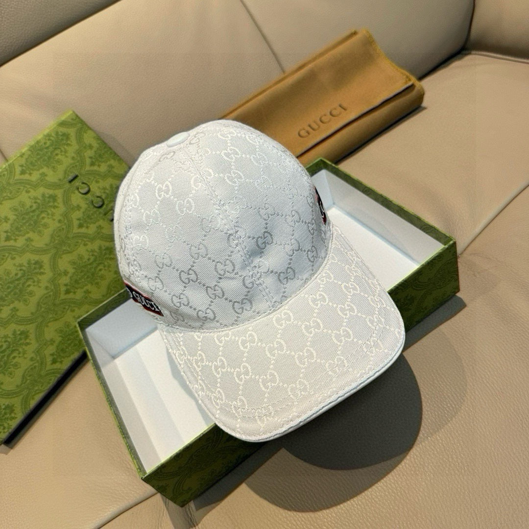 Gucci baseball cap in white GG monogram fabric, curved brim, and logo trim band.