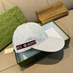 Gucci baseball cap in white GG monogram with curved brim and red-and-black logo band.