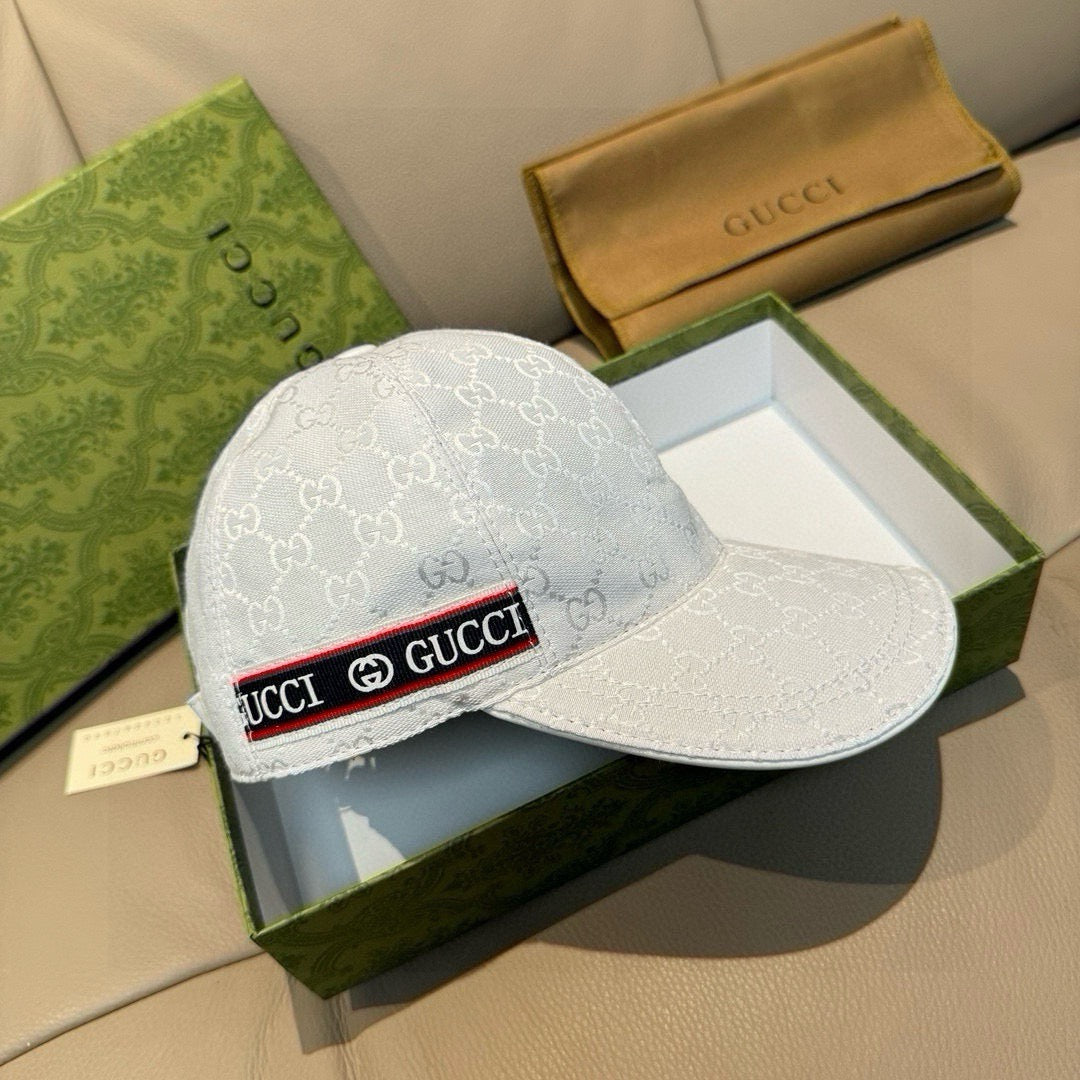 Gucci baseball cap in white GG monogram with curved brim and red-and-black logo band.
