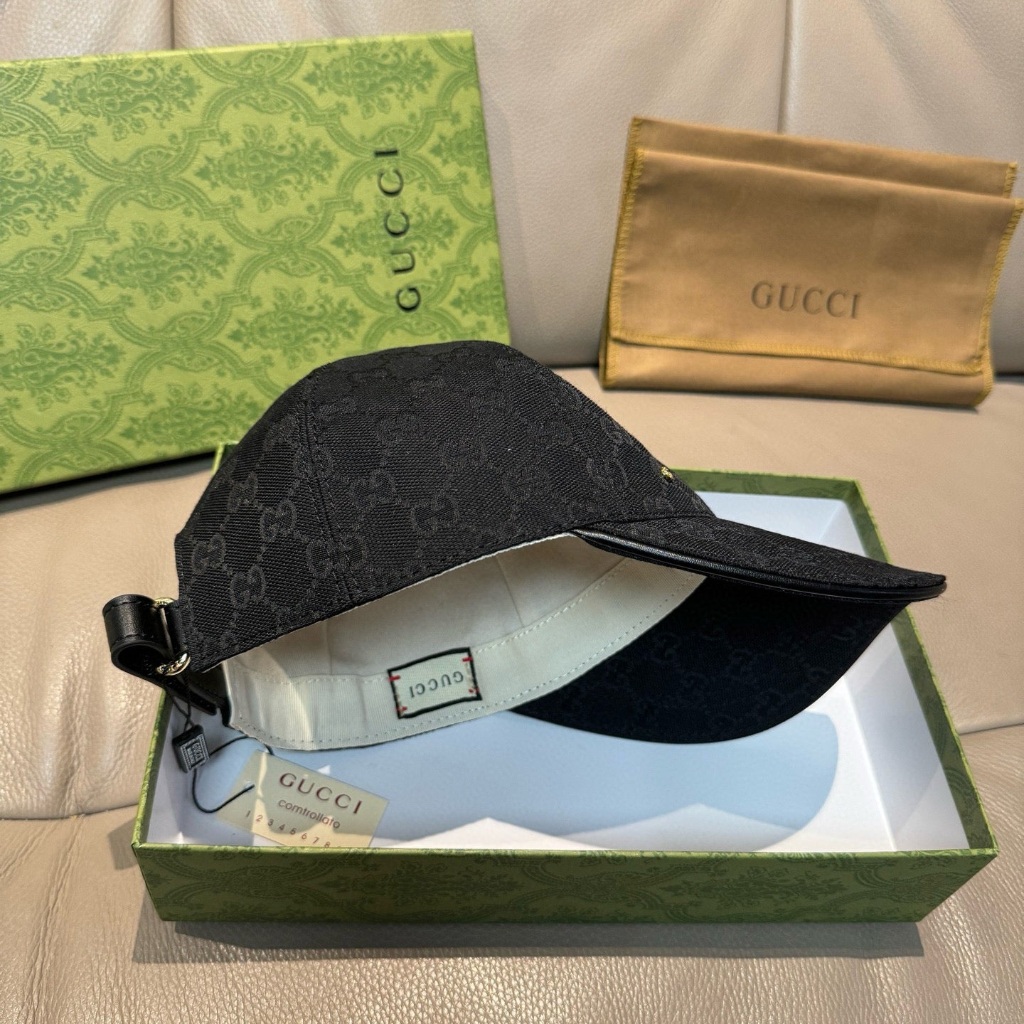 Black Gucci monogram baseball cap side with adjustable strap and light interior lining
