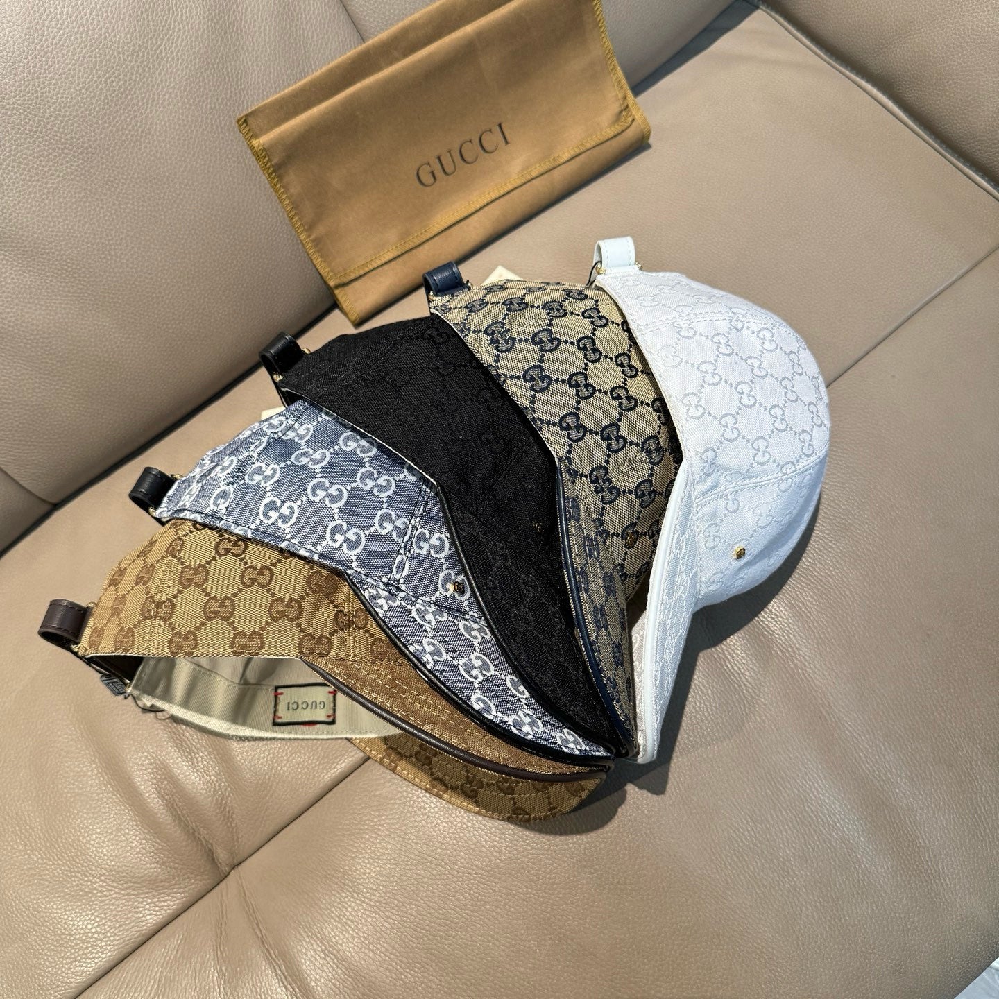 Gucci monogram baseball cap trio in black, white, and tan with curved brims