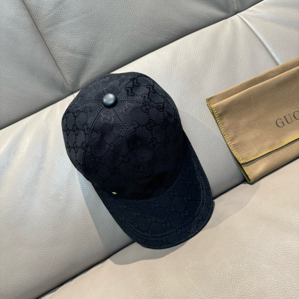 Black Gucci monogram baseball cap with front snap button and curved brim