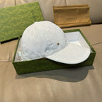 White GG monogram cap with curved brim and front gold emblem
