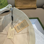 White GG monogram cap with fabric strap and hanging product tags
