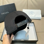 Prada black cap with side button hardware and interior opening
