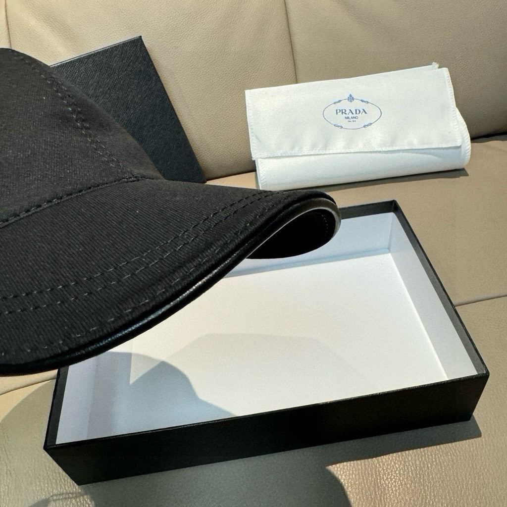 Prada black cap brim detail with visible stitching and curved edge