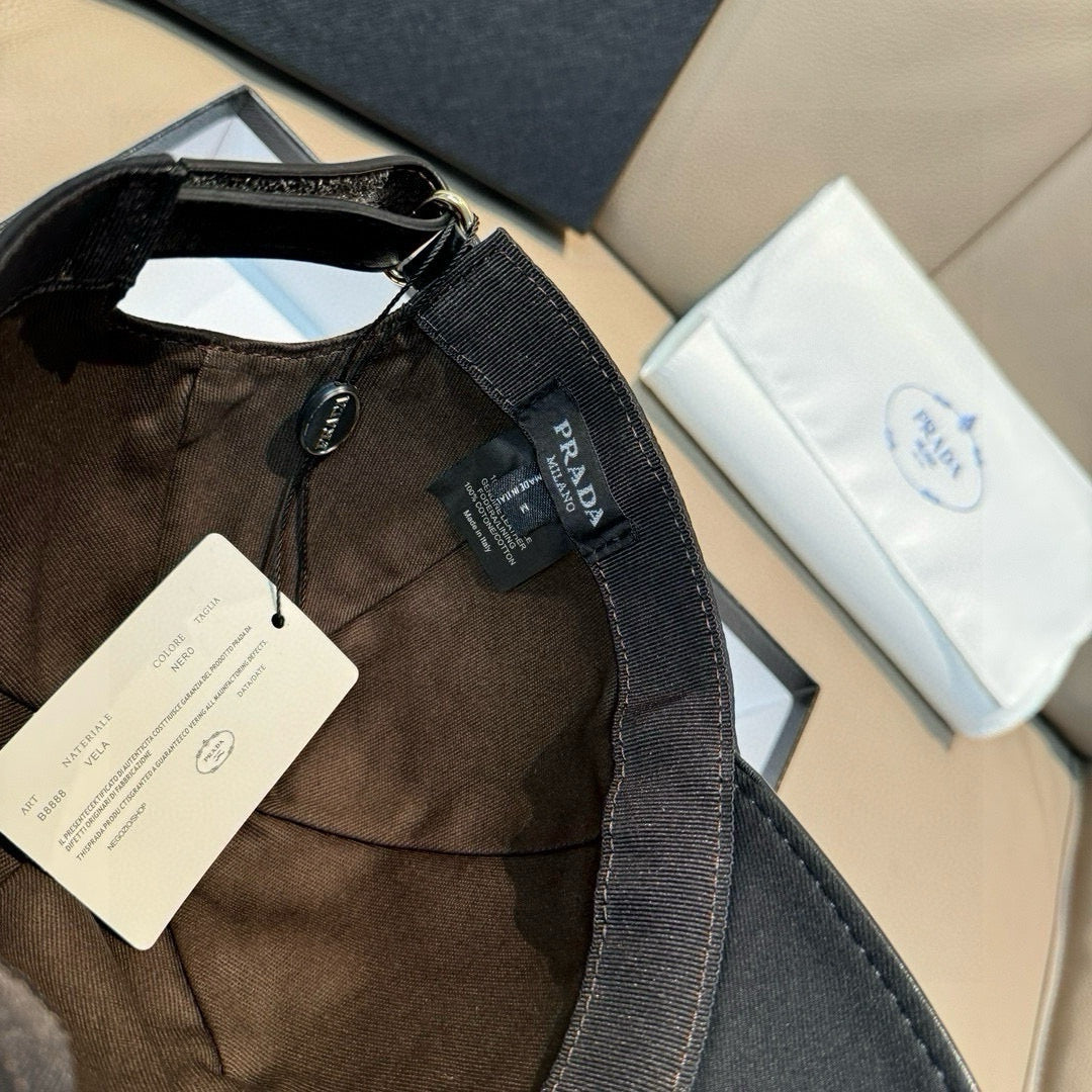 Prada black cap back strap and interior tag in an open box