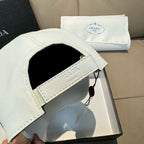 White Prada cap with black interior lining and adjustable strap with hanging tag