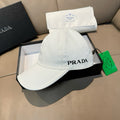 White Prada baseball cap with embroidered PRADA logo on the front and curved brim