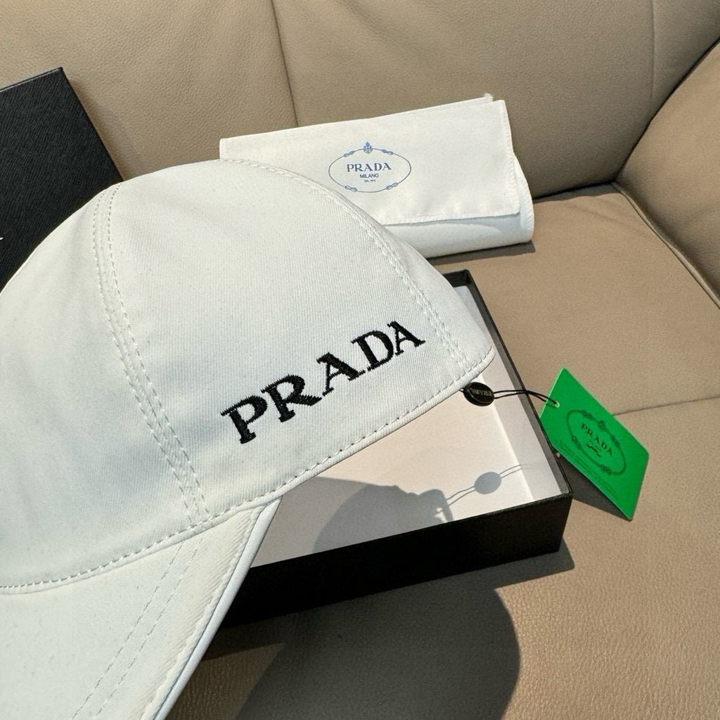 White Prada cap with side PRADA logo text and curved brim