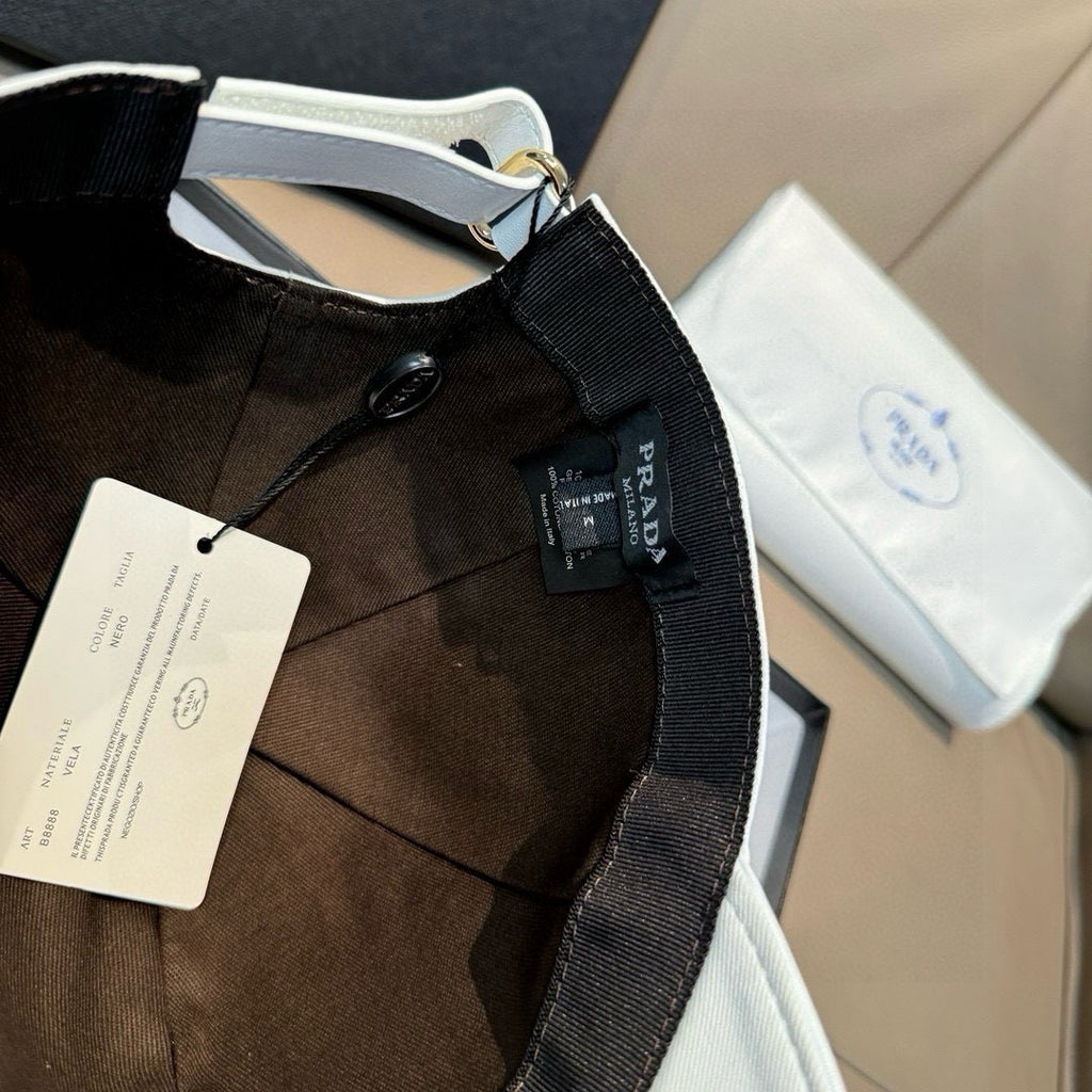 Black cap with Prada web strap and hanging label tags