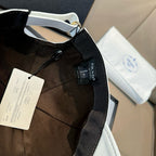 Black cap with Prada web strap and hanging label tags