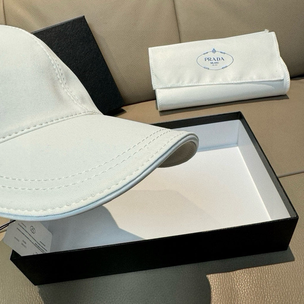 White Prada cap brim detail with stitched edge over a hat box