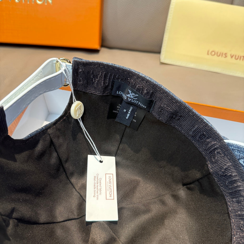 Denim blue cap interior with black fabric band and hanging tag from adjustable strap