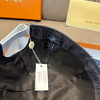 Denim blue cap interior with black fabric band and hanging tag from adjustable strap
