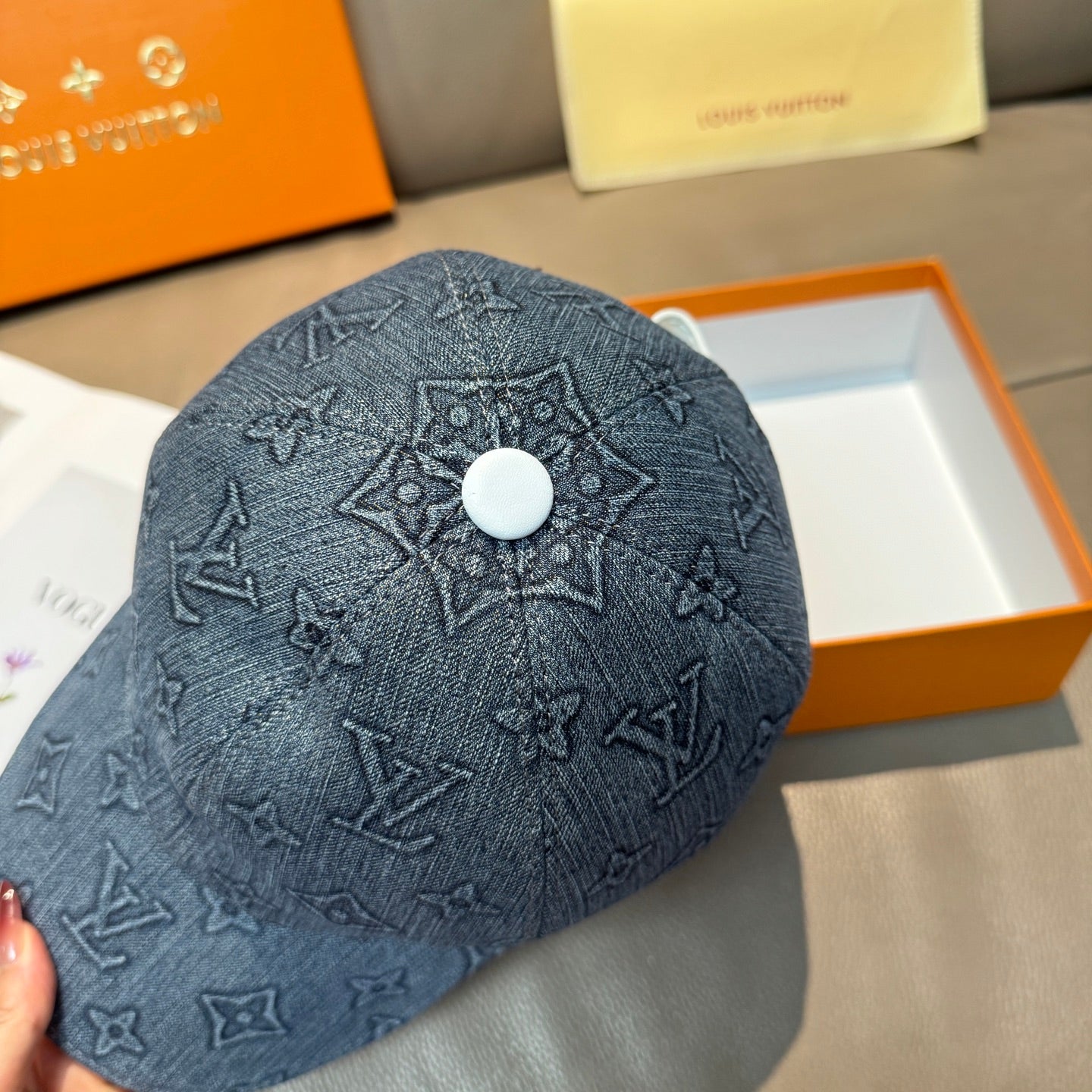 Denim blue baseball cap with Louis Vuitton monogram pattern and round button at top