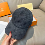 Louis Vuitton dark denim baseball cap with monogram print, curved brim, and eyelets