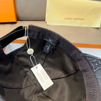 Louis Vuitton denim cap with adjustable strap, black lining, and hanging tags