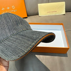 Louis Vuitton denim cap close-up of curved brim and tan edge trim