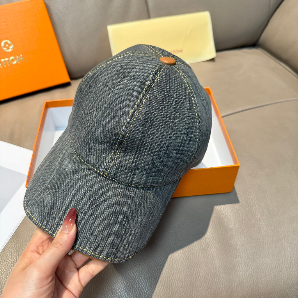 Louis Vuitton denim baseball cap, dark blue-gray, front view with tan button