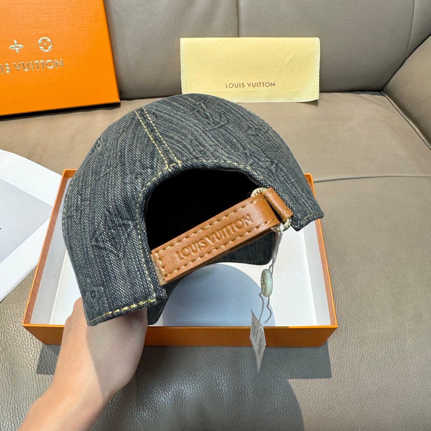 Louis Vuitton denim cap underside view with tan leather brand patch